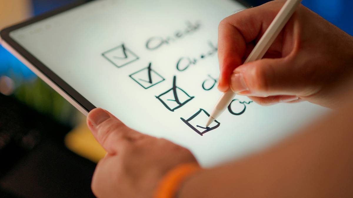Man smiling while writing adaptive SMART Goals for sustainable weight loss